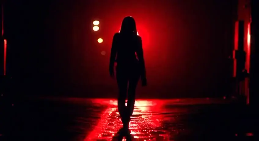Frame from Night cars and red-lit silhouettes