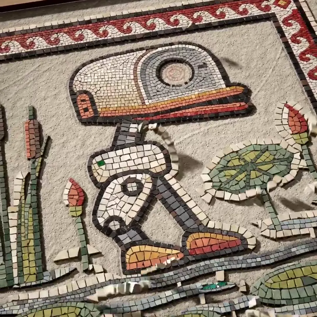Frame from Stone mosaic duck with a scroll border