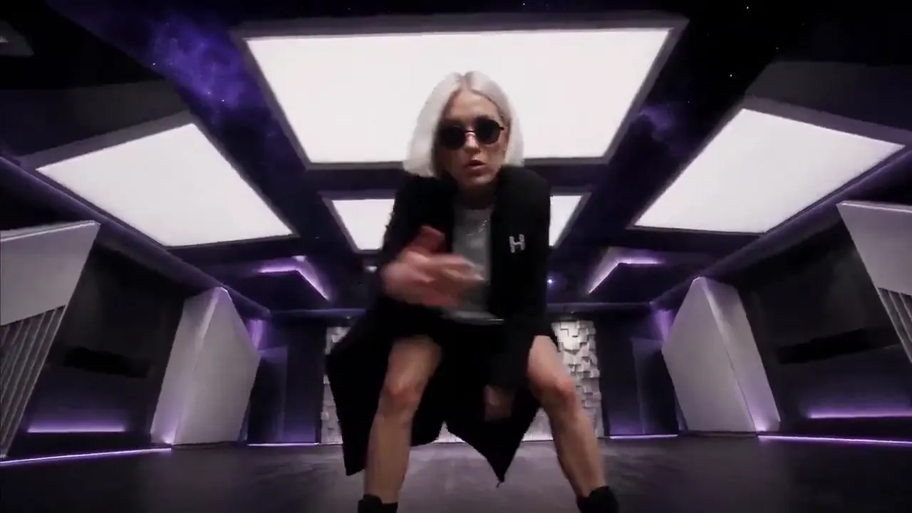 Frame from White-haired performer in violet studio