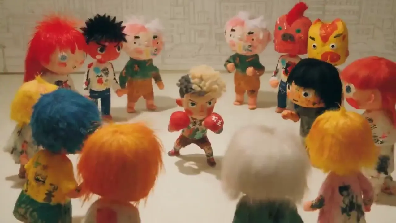 Frame from Wool-haired boxer among painted dolls